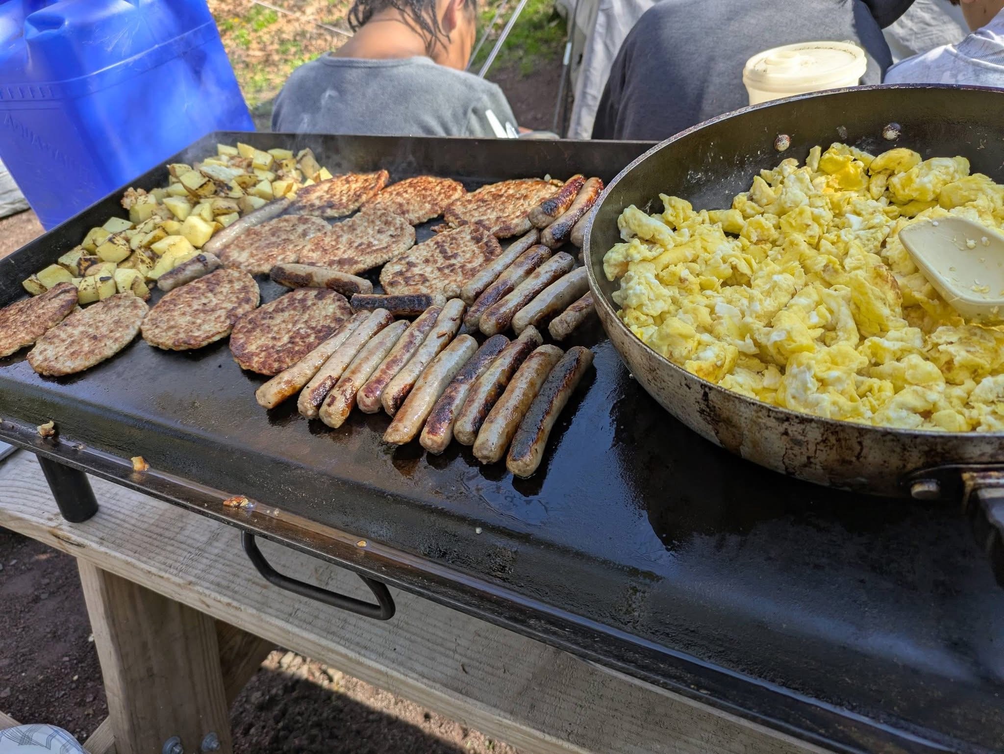 Scouts at campsite cooking and learning outdoor skills