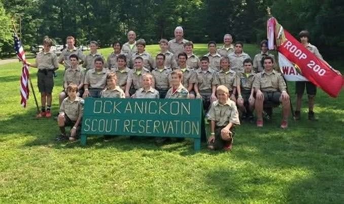 Scout troop camping together in all-weather conditions